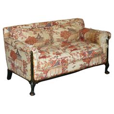 an old fashioned couch with floral fabric on it