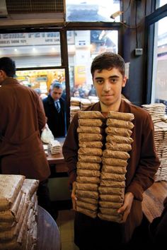 a man is holding stacks of sandbags in front of him