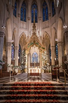 the interior of a cathedral with christmas decorations on the alter and stairs leading up to it