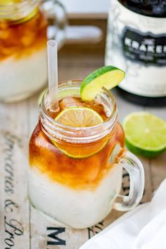 a pitcher filled with liquid and lime slices