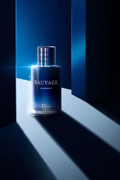 a bottle of sauvage on a blue background with light coming through it