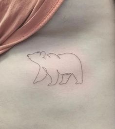 a woman's stomach with a small bear tattoo on the left side of her stomach