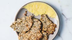 a plate with crackers and butter on it