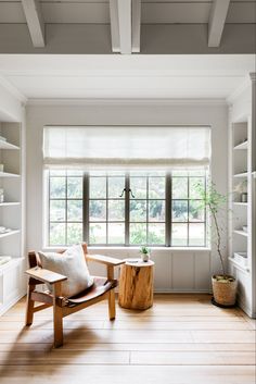 a living room with white walls and wooden floors