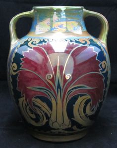 a large vase with designs painted on it's sides, sitting against a black background