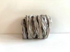 a roll of yarn sitting on top of a white table