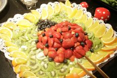 a platter filled with sliced fruit and vegetables