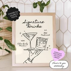 a hand holding a martini glass with the words signature drinks written on it in black ink