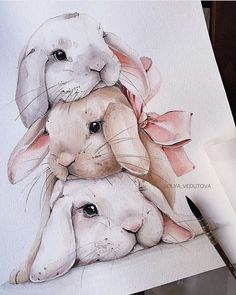 a watercolor drawing of two rabbits hugging each other with a pink bow on their head