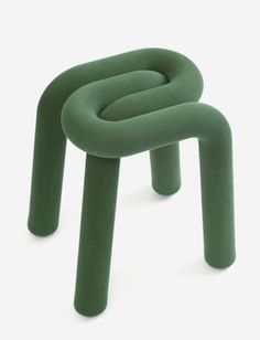 a small stool made out of green fabric with two legs and one foot in the shape of an o - ring