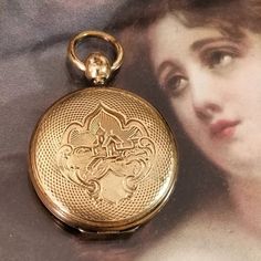 Beautiful Antique Locket Pendant From The Victorian Era, Likely 1880s! It Has An Engraved Lake House With Dock Scenic Design On Both Sides And A Blank Shield That Your Jeweler Can Engrave With An Initial. Pocket Watch Styling. The Hinge Is Good And It Snaps Shut And Stays Shut. Weathered Gold Tone Metal With Lots Of Patina. There Is A Tiny Space Between The Sides When It Closes, Nothing Major. At One Point It Likely Held A Tin Type Photo And A Lock Of Hair, Now Inside Is Empty For Your Special Mementos. Pendant Only, No Chain. Measures Approx 1 3/4" From Top Of Loop To Bottom Of Locket. Ships Fast! Sunj8988vg3m6b Mourning Heirloom Mill Scene Keepsake Jewelry Jewelry Rings Unique, Locket Gold, Vintage Jewelry Antique, Lock Of Hair, Victorian Locket, Antique Locket, Rings Unique, Tiny Space, Scenic Design