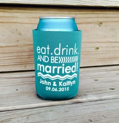 a can cooler with the words eat, drink and be married printed on it sitting on a wooden surface