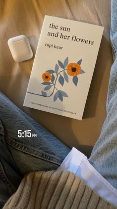 a book sitting on top of a bed next to an air freshener dispenser