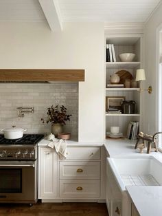 a kitchen with an oven, stove and sink in it's center island area