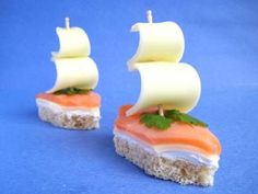 two pieces of food that look like a boat on top of each other, with the sails down