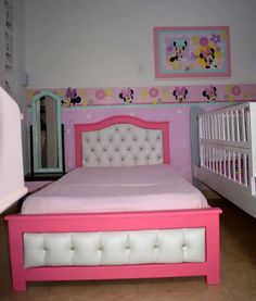 a child's bedroom with pink and white furniture