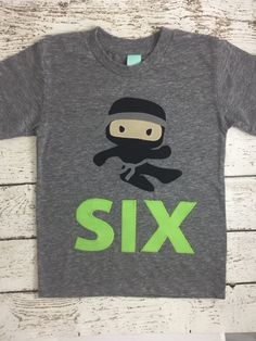 a child's t - shirt that says six with a cartoon character on it