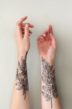 two hands with tattoos on their arms and one has a leaf tattoo on the arm