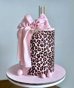 a pink and black leopard print birthday cake