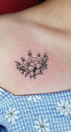 a woman's chest with flowers and vines tattoo on her left side ribcage