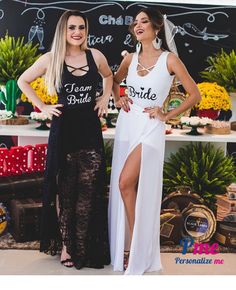 two beautiful women standing next to each other in front of a chalkboard sign with writing on it