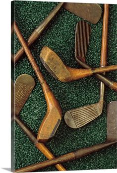 several different types of golf clubs laying on the ground