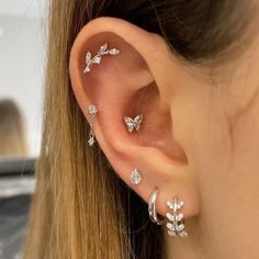 a close up of a person's ear with three different types of piercings