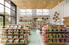 the inside of a store filled with lots of bottles and shelves full of goods on display