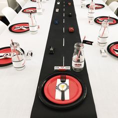 the table is set with red and black plates