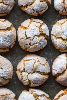 freshly baked pastries are arranged on a baking sheet with powdered sugar toppings