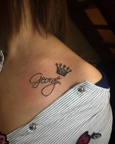 a woman with a crown tattoo on her shoulder and the word george written in cursive font