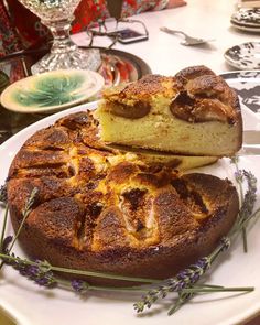 a cake on a plate with lavender sprigs