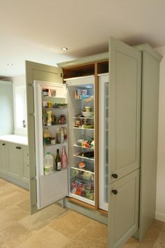 an open refrigerator in a kitchen with the door wide open and shelves full of food