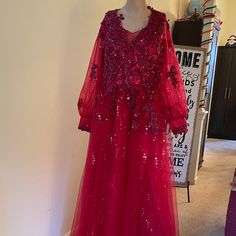 a mannequin dressed in a red dress with sequins and beads on it