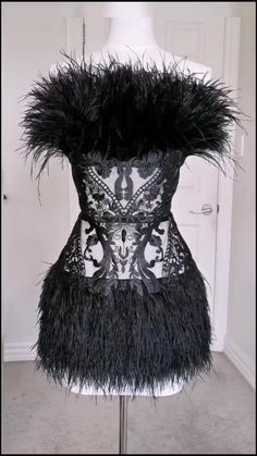 a black and white dress with feathers on it