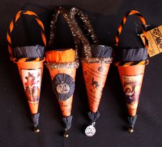 four halloween cones with decorations on them