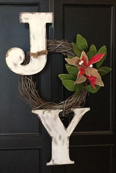 a door hanger with the letter j on it and a flower in front of it