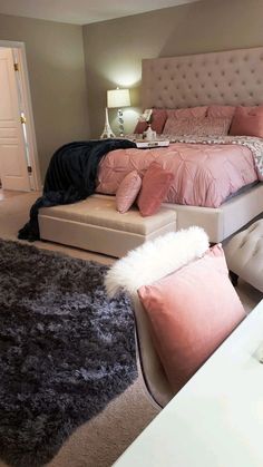 a bedroom with a bed, chair and ottoman