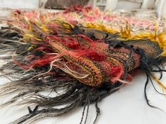 a pile of multicolored hair sitting on top of a white table