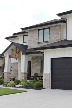 a large house with two garage doors and windows