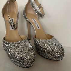 New Authentic Jimmy Choo Silver Glitter Leather Stiletto Heels. Size 40.5 (Us 7.5) Heel Height 12 Cm, Platform Height 3 Cm. Please Do Not Ask Me To Text You Or Someone Else With Extra Pictures Or Videos Of The Item. These Pictures Are Enough! All Shoes Listed Are New And Never Been Used, So They Are In Tip Top Condition And Damage Free. If Interested Purchase Or Make Offer Glitter Ankle Strap Heels For Events, Glitter Heels With Ankle Strap For Events, Glitter Open Heel Heels For Gala, Formal Glitter Wedding Shoes With Ankle Strap, Evening Glitter Heels With Almond Toe, Glitter Round Toe Heels For Gala, Glitter Heels With Round Toe For Gala, Luxury Glitter Heels For Event, Evening Heels With Shimmer And Round Toe