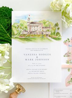 the wedding stationery is surrounded by white flowers and greenery, including hydrangeas