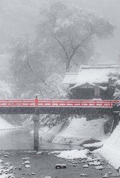 a bridge over a river covered in snow