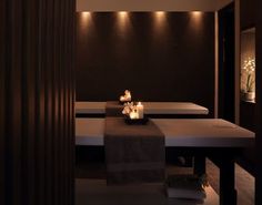 a spa room with candles and towels on the tables