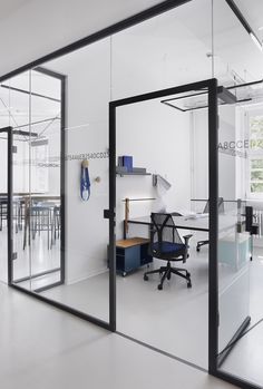 an office with glass walls and desks