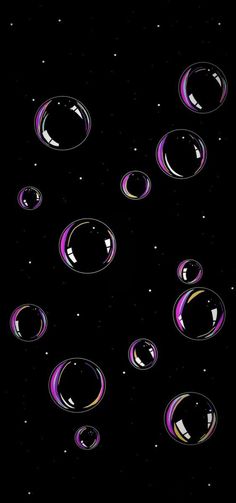 soap bubbles floating in the air on a black background with space and stars around them