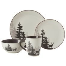 the black and white dinnerware is decorated with deer, pine trees, and snowflakes