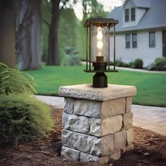 a light that is on top of a stone pillar