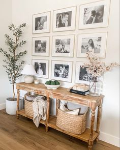 a wooden table topped with baskets under pictures