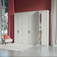 a living room with red walls and white closets in it's center area